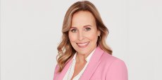 genie francis as laura on general hospital where a pink blazer and white shirt.