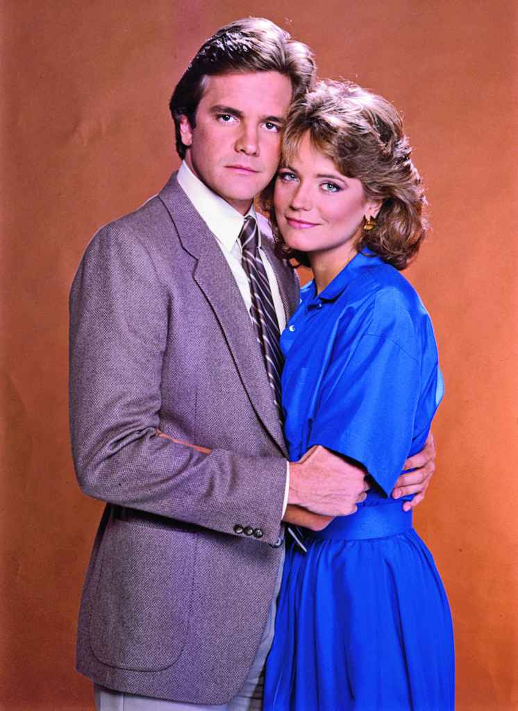 lane davies as mason and harley jane kozak as mary pose check to cheek on santa barbara.