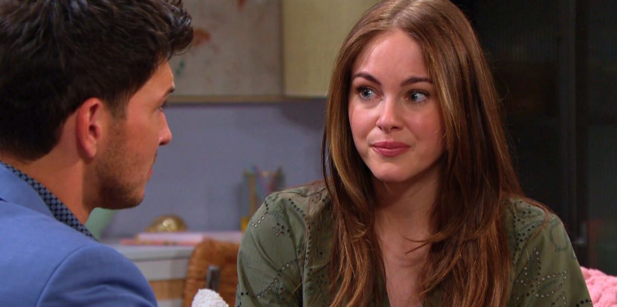 abigail klein as stephanie talking to robert scott wilson as alex on the couch on days of our lives.