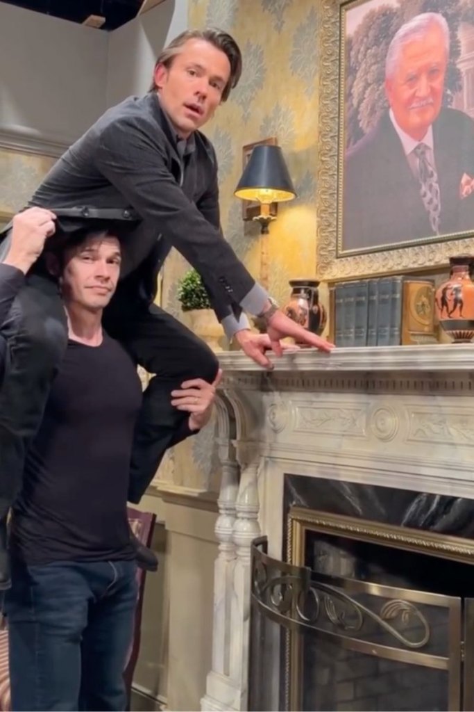 john-paul lavoisier on paul telfer's shoulders adjusting john aniston portrait at days of our lives.